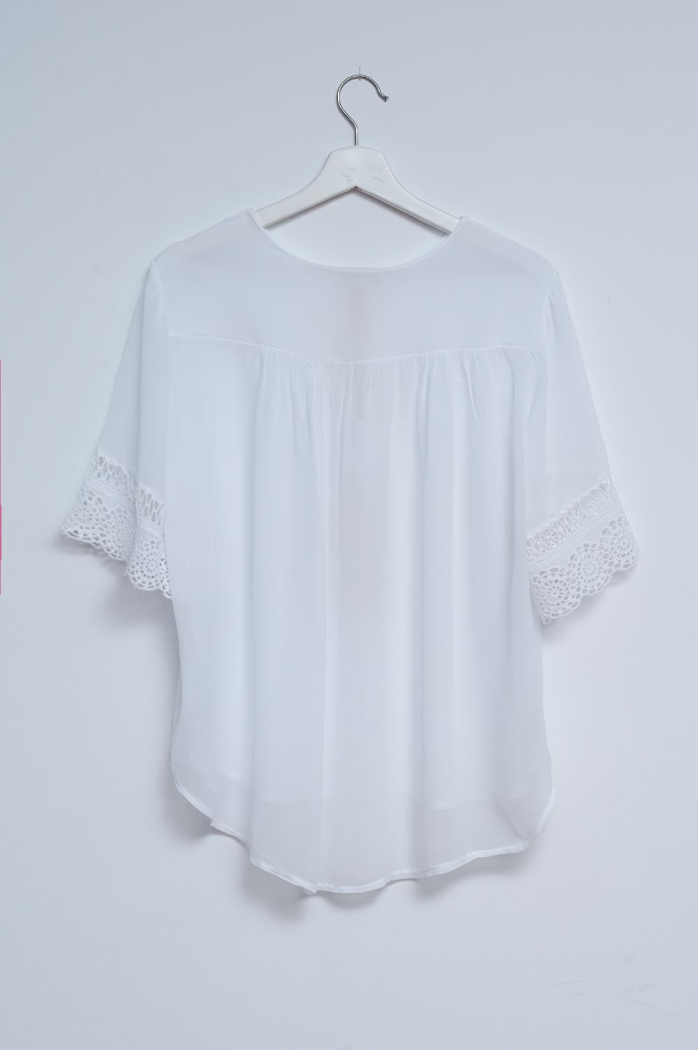 Blouse with embroidery and tie front in white