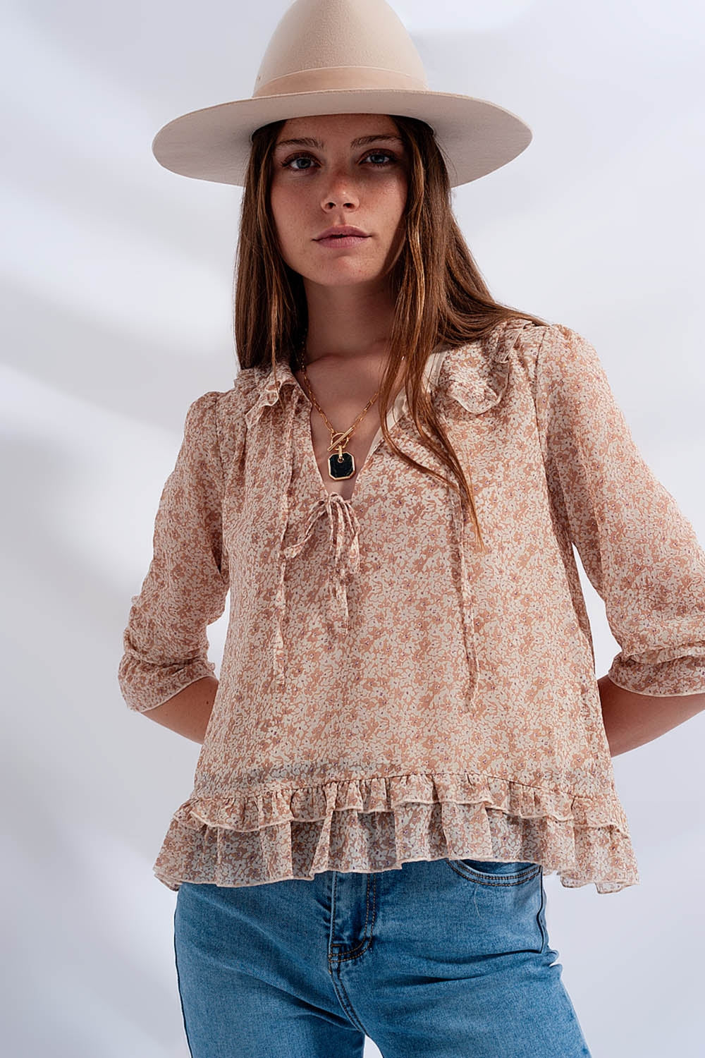 Chiffon blouse with bow on the front and fine floral print in beige