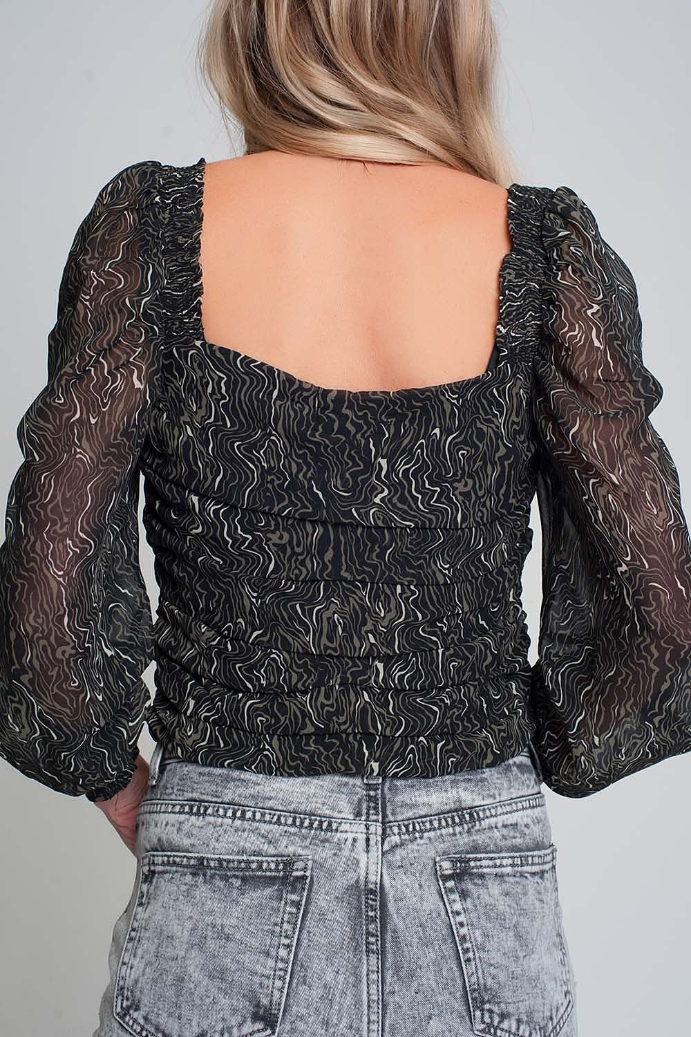 Transparent blouse with long sleeves geoprint in black color with elastic cuffs