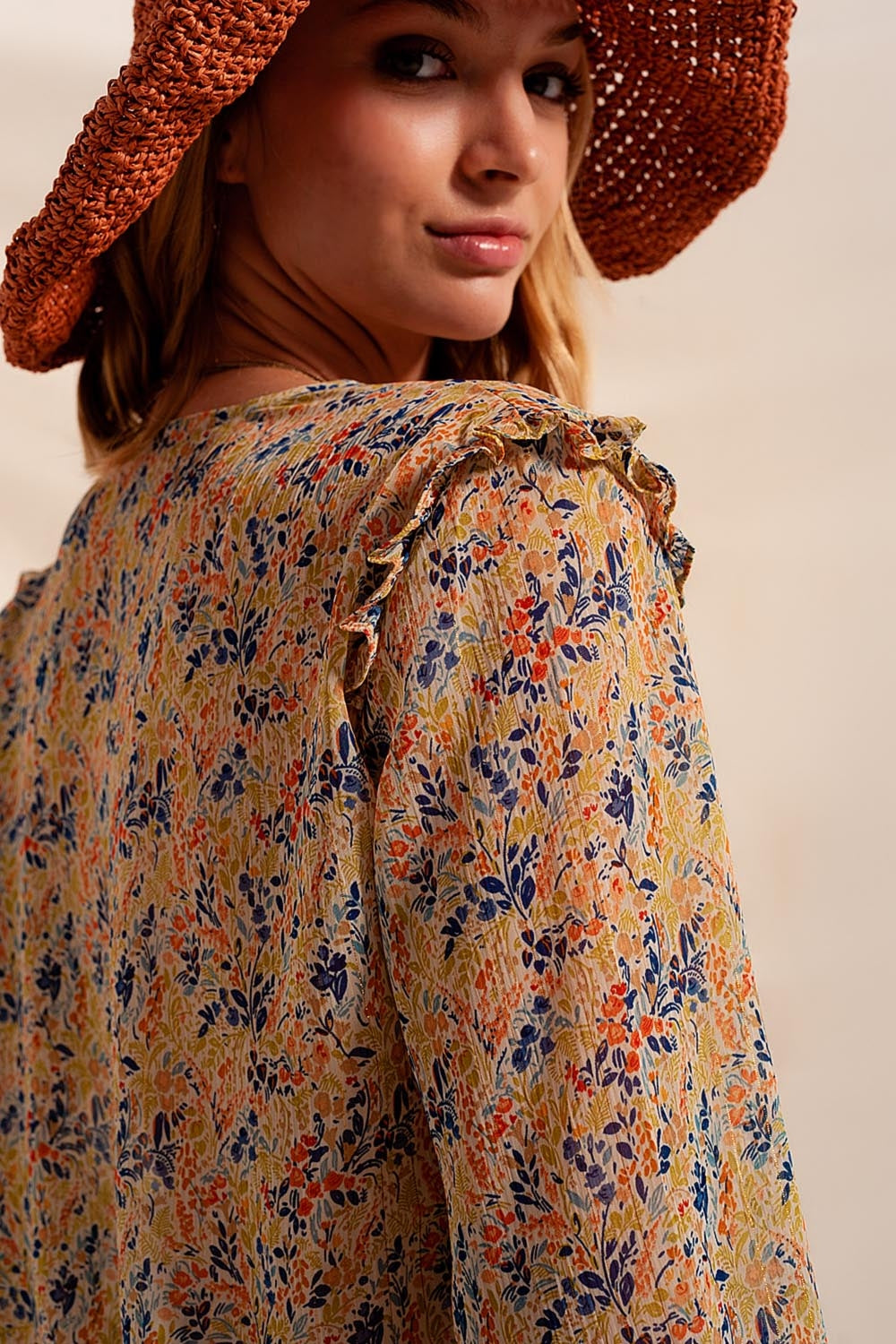 Floral and metallic blouse with green ruffles