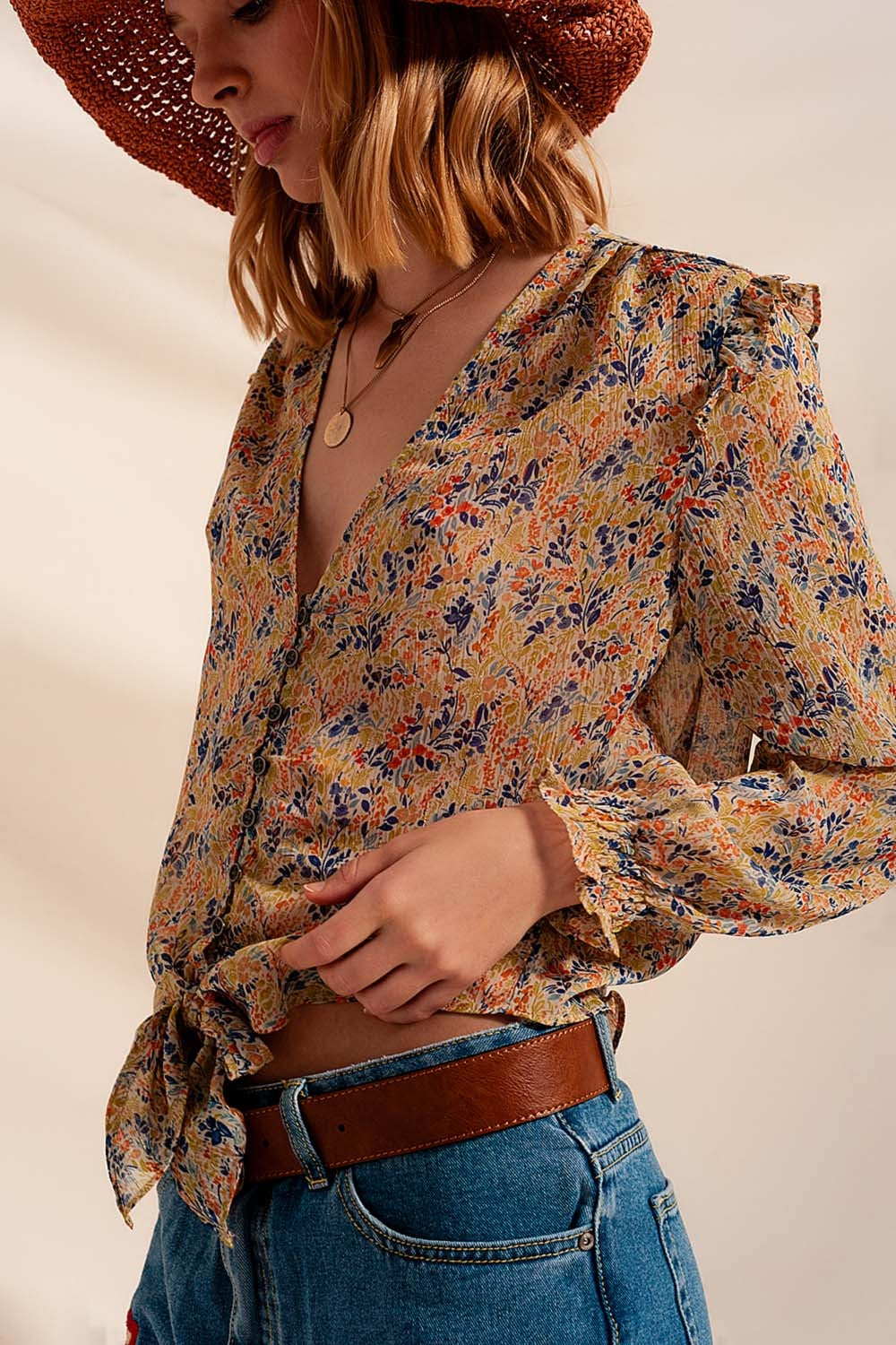 Floral and metallic blouse with green ruffles